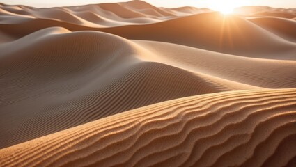 A stunning sunset casts a vibrant glow across the large rippled desert, shining light on the sandy peaked dunes.