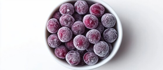 Overhead shot of frozen cranberries in a white bowl against a white background for healthy eating and winter holiday themes