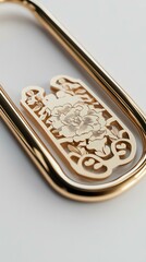 Elegant golden paperclip with floral design.