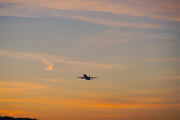 Passenger airplane ascending at Swiss Airport Zürich Kloten on a spring sunset with colorful sky background. Photo taken April 8th, 2025, Zurich Kloten, Switzerland.