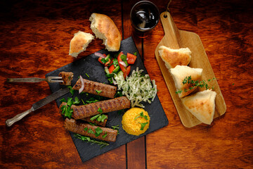 Savory kebabs with fresh salad and bread offer a delightful dining experience