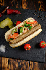 Savory sandwich filled with grilled meat, fresh vegetables, and vibrant colors, inviting taste