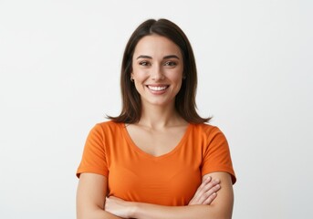Fototapeta premium Portrait of a woman smiling with arms crossed wearing orange shirt isolated on white background