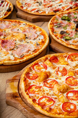 Colorful selection of pizzas topped with fresh ingredients captivates diners during a lively event