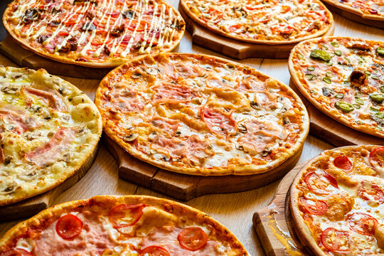An inviting display of multiple pizzas with vibrant toppings, perfect for sharing among friends