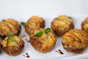 stuffed champignons frying pan with stuffed mushrooms and vegetables on the table, top view