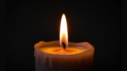 Illuminated warm wax candle with flickering flame