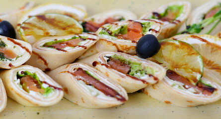 meatloaf with meat and herbs Italian style wrap piada wheat tortilla with tuna fish, vegetable and avocado served as closeup on a Nordic design plate