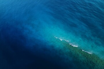 Obraz premium Aerial View of Turquoise Coral Reefs and Deep Blue Ocean Water
