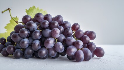 Fototapeta premium Macro shot of candied black grapes against a white backdrop