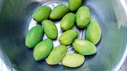 Dew-Kissed Green Mangoes in Shiny Bowl