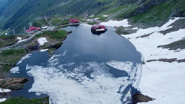 Aerial footage of the glacier lake of Balea in the Fagaras Mountains, in central Romania