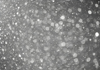Abstract White Bokeh on a Dark Gray Background with Snowfall