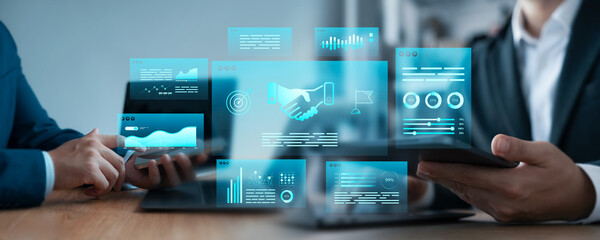 Business partnership concept with two professionals shaking hands and analyzing data using futuristic digital interfaces, representing collaboration, trust, and innovation.