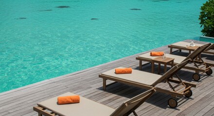 Obraz premium Deck chairs near turquoise water at tropical resort
