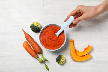 Children's vegetable and fruit puree, on a light background.