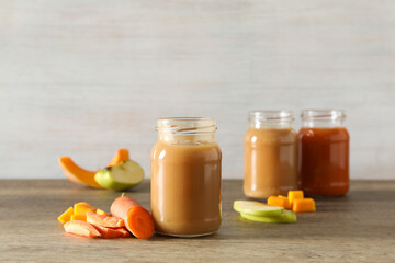 Children's vegetable and fruit puree, on a light background.