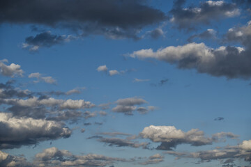 Scenic view of a partly cloudy sky with fluffy clouds against a serene blue backdrop