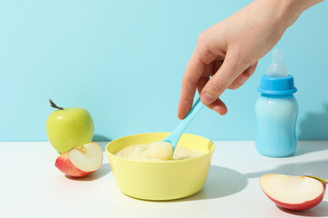 Children's puree from fruits and vegetables, on a blue background.