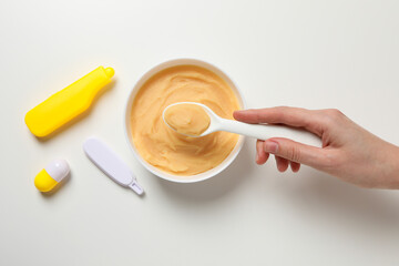 Children's vegetable and fruit puree, on a light background.