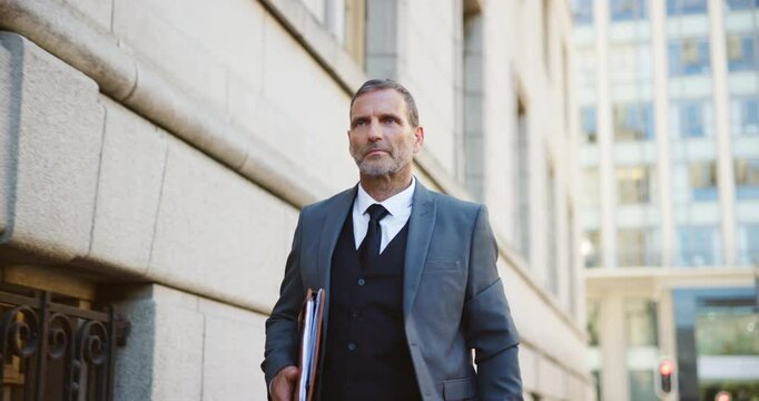 City, walking and watch with lawyer man outdoor as legal council for court case or trial. Documents, schedule and time with attorney at law in urban town for commute to appointment as advocate