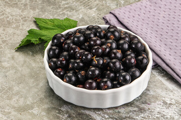 Ripe black currant in the bowl