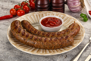 Grilled beef sausages with sauce