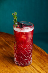 non-alcoholic cocktail with ice and a sprig of rosemary
