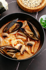 Tom yum soup with mussels, shrimp, mushrooms and lime