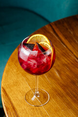 cosmopolitan cocktail with ice and orange