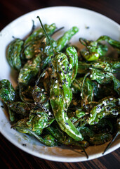 Close up of blistered shishito peppers with sesame seeds