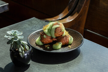 Plated beignets served with green foam