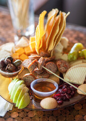 Charcuterie pub board with sausage fruits and cheeses vertical