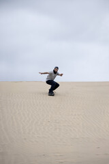 Sandboarder cruising down dune. Cañoncillo, Perú.