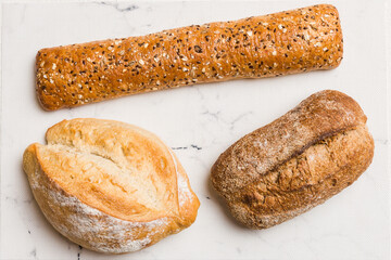 Homemade natural breads. Different kinds of fresh bread as background, top view with copy space