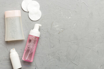 Micellar cleansing water and discs to remove cosmetics and cleanse the skin on colored background. Copy space top view