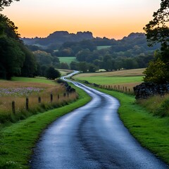 Fototapeta premium Serene Sunrise Over Rolling Hills Picturesque Country Road Winding Through Lush Green Fields