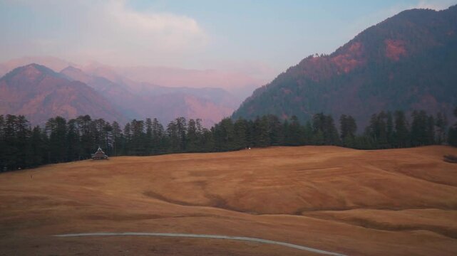 Scenic view of Shangarh meadows surrounded by Pine Trees and Himalaya mountains in Sainj Valley, Himachal Pradesh, India. Celestial meadows.  Mountains landscape.
