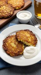 Delicious Golden Fried Potato Pancakes With Sour Cream Photo