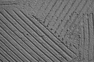 Fototapeta premium gray background, photo shows texture of decorative plaster on concrete wall close-up
