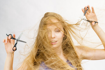 Girl with scissors for haircutting