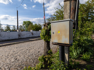 Box with an elektro equipment fixed on the pillar
