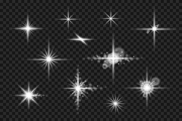 set of shining stars with long cross and snowflake-like rays. beautiful bokeh effect with light diffusion on transparent background
