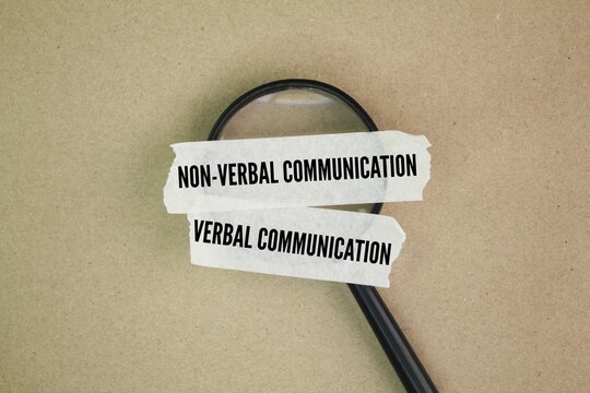 Magnifying glass and stickers with the words Difference Between Verbal and Nonverbal Communication.