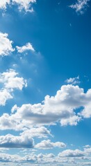 Obraz premium Fluffy White Clouds Against A Vibrant Blue Sky on Sunny Day