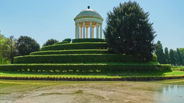 Parco Querini is green area of city of Vicenza, Italy. Monopteros is circular colonnade supporting roof but without any walls. Unlike tholos, it does not have walls making cella or room inside.