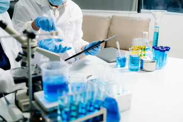 Closeup scientist science research biology chemistry chemical experiment microscope virus flask dna biohazard
