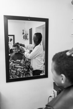 Barber interacting with young client