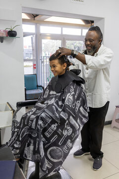 Young boy having his hair cut