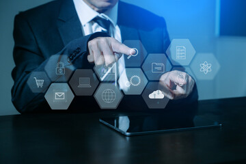 close up of businessman working with laptop computer and smart phone on desk  with virtual icon diagram.